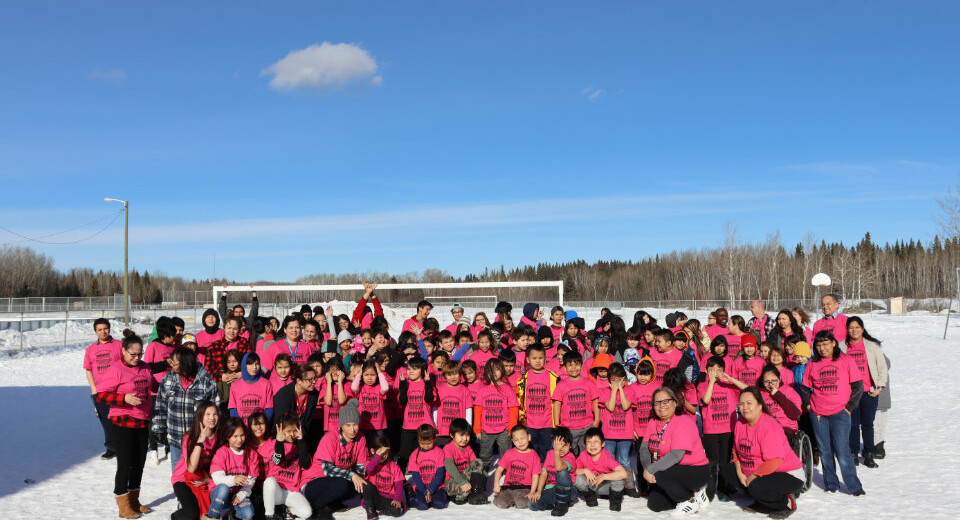 group of students in pink shirt outside in winter